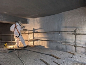A below-grade equalization tank being spray-applied with Epoxytec Series 456 CPP Sprayliner in Ontario